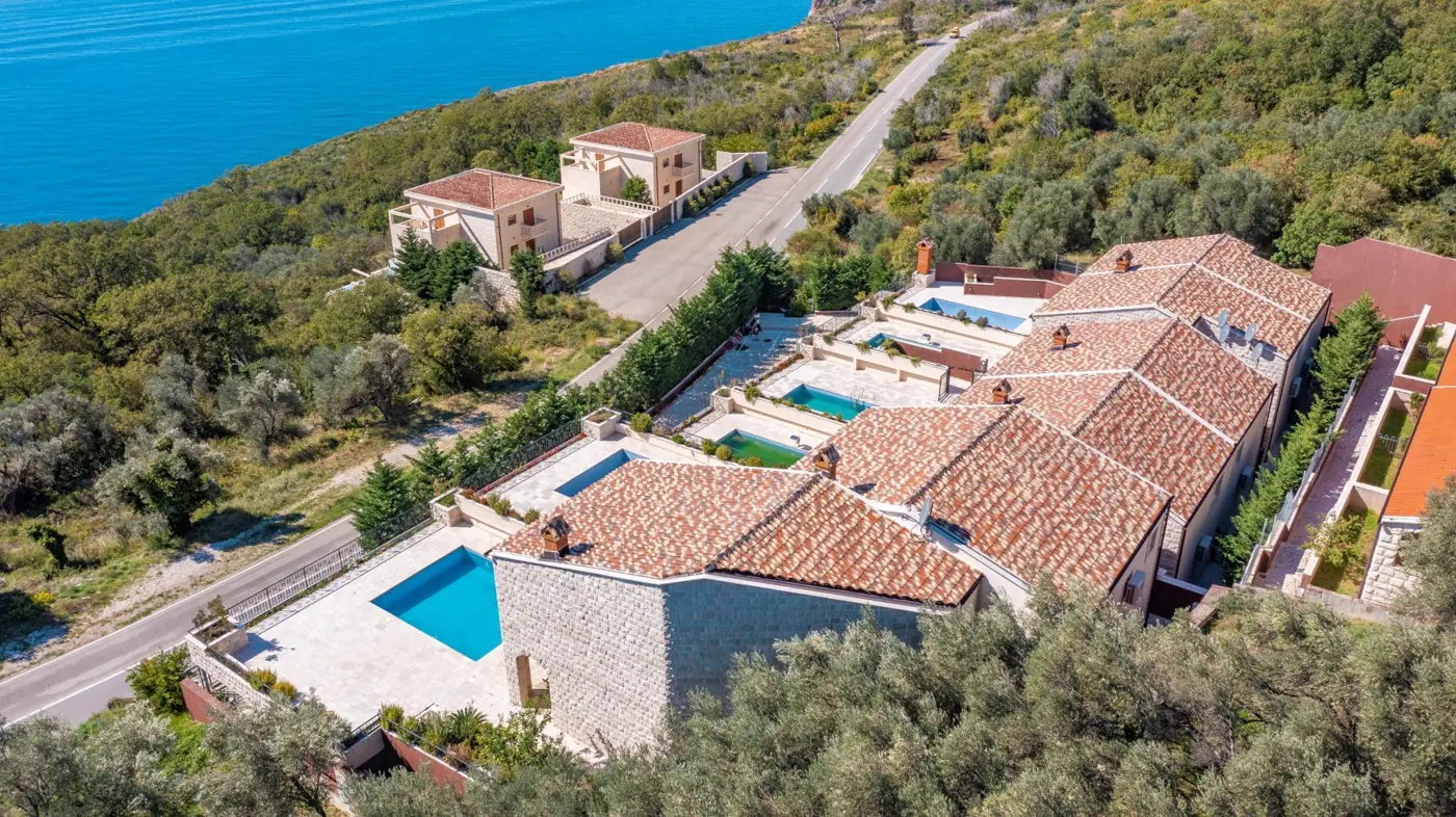A complex of stone villas with swimming pools and a panoramic view of the sea, Budva, Reževići
