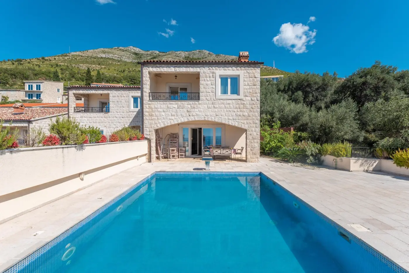 A complex of stone villas with swimming pools and a panoramic view of the sea, Budva, Reževići